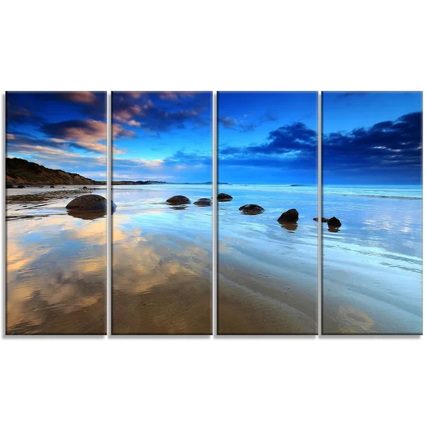 Design Art 'Cloudy Sky Over Moeraki Boulders' Photographic Print on Wrapped Canvas - Size: 20 inch H x 40 inch W x 1 inch D, Blue